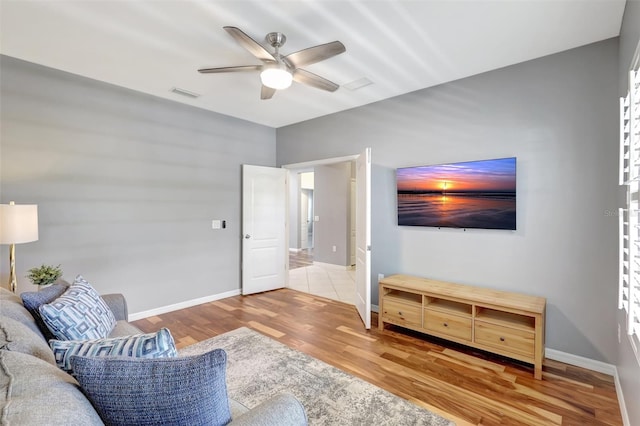 living room featuring ceiling fan and wood-type flooring