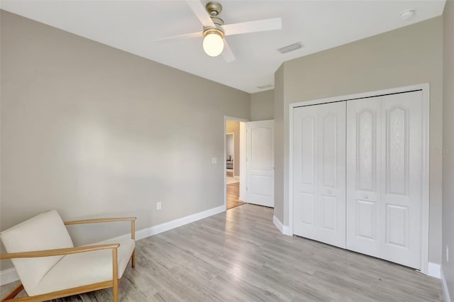 sitting room featuring ceiling fan and light wood-type flooring