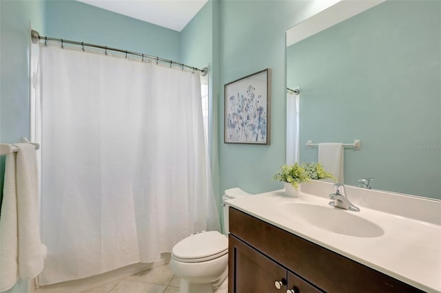 bathroom with tile patterned flooring, vanity, and toilet