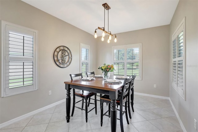 dining room featuring a chandelier and light tile patterned floors