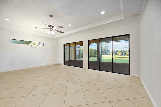 empty room featuring ceiling fan with notable chandelier, a tray ceiling, crown molding, and light tile patterned flooring