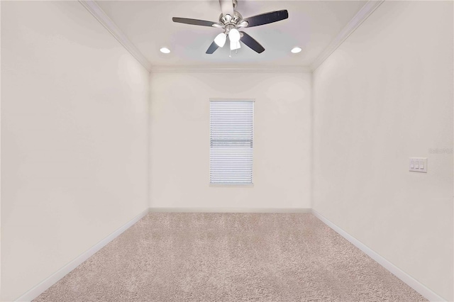 empty room featuring ceiling fan, ornamental molding, and carpet floors