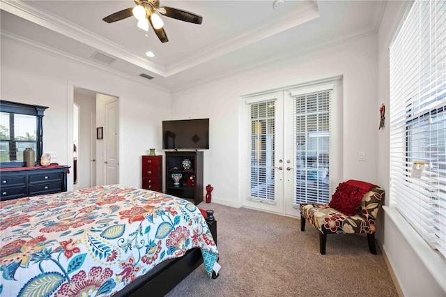 carpeted bedroom featuring french doors, access to outside, a tray ceiling, ceiling fan, and crown molding