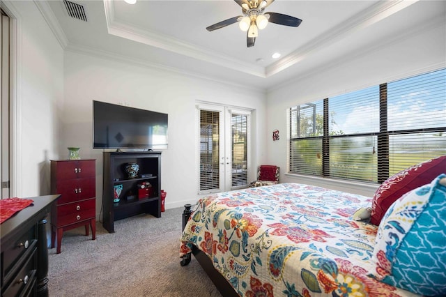 carpeted bedroom featuring access to outside, a tray ceiling, ceiling fan, and ornamental molding