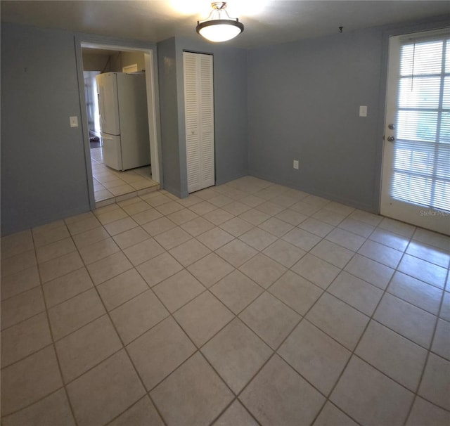 unfurnished room with light tile patterned floors