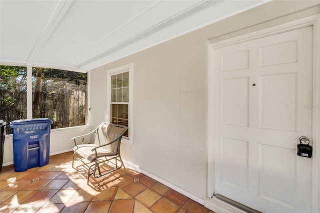 sunroom with beam ceiling