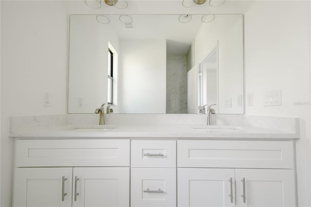 bathroom featuring a sink and double vanity