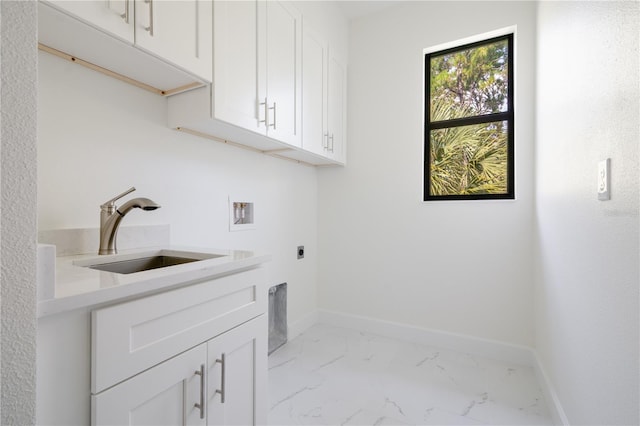 laundry room featuring cabinets, sink, electric dryer hookup, washer hookup, and light tile patterned flooring