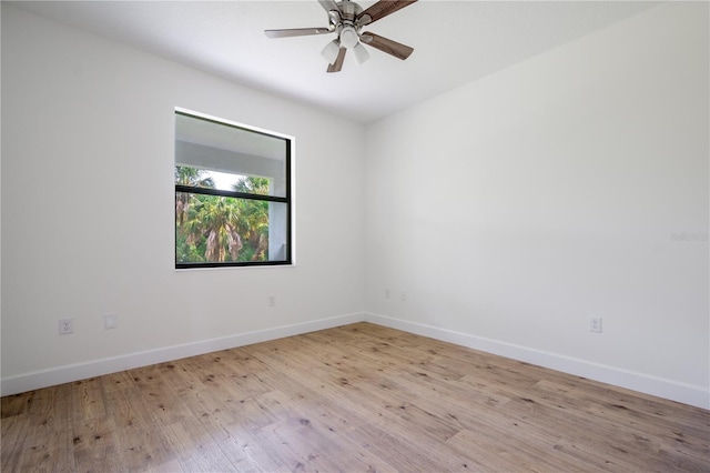 unfurnished room featuring a ceiling fan, light wood-style flooring, and baseboards