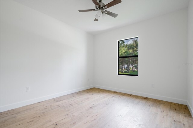 unfurnished room with ceiling fan and light wood-type flooring