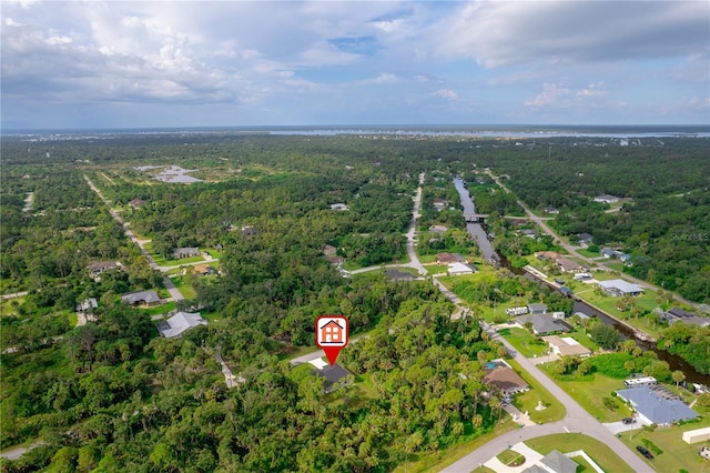 bird's eye view with a wooded view