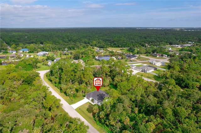 drone / aerial view with a residential view and a wooded view