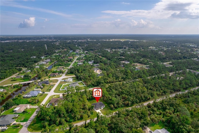 birds eye view of property featuring a forest view