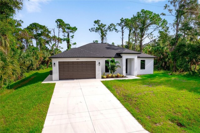 view of front facade featuring a garage and a front lawn