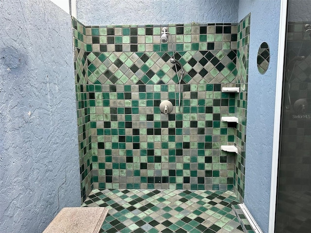 bathroom with a tile shower