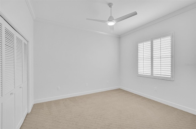 unfurnished bedroom with ceiling fan, ornamental molding, a closet, and light carpet