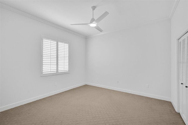 unfurnished bedroom featuring ceiling fan, ornamental molding, a closet, and light carpet