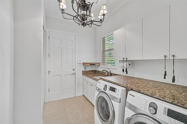 laundry room with cabinets, washer and clothes dryer, crown molding, a chandelier, and sink