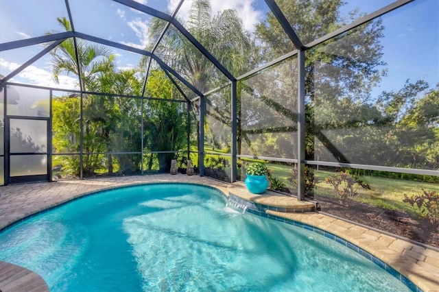 view of pool with glass enclosure