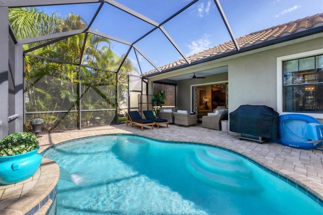 view of pool with ceiling fan, a lanai, an outdoor hangout area, and a patio area