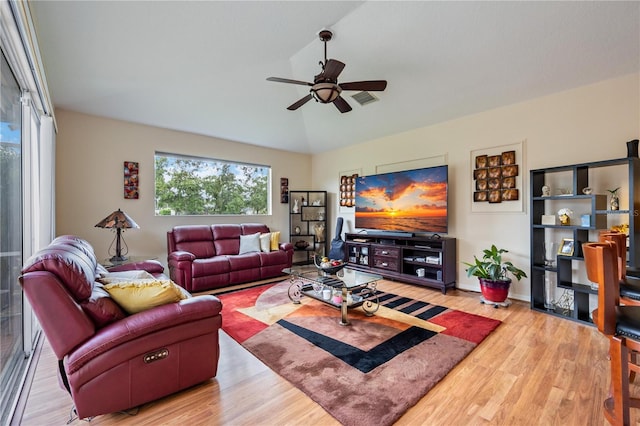 living room with wood-type flooring, vaulted ceiling, and ceiling fan