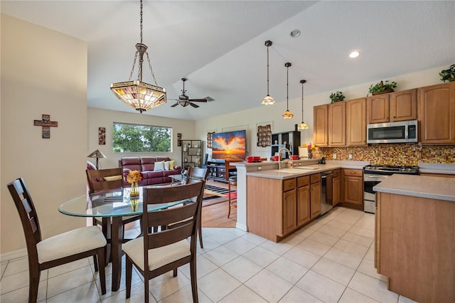 kitchen with backsplash, hanging light fixtures, ceiling fan, kitchen peninsula, and stainless steel appliances