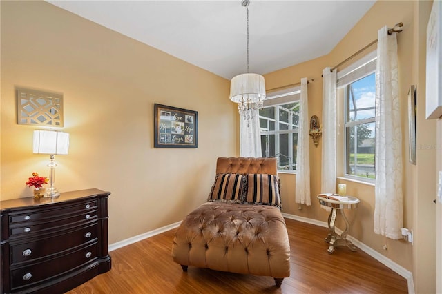 sitting room with light wood-type flooring and a notable chandelier