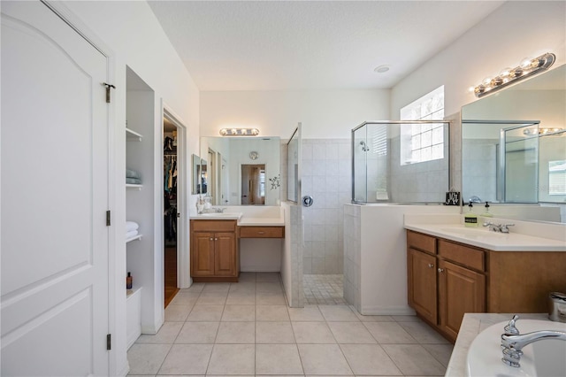 bathroom featuring tile patterned floors, vanity, and separate shower and tub