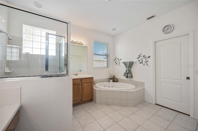 bathroom with tile patterned flooring, shower with separate bathtub, and vanity