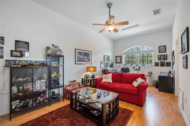 living room featuring light hardwood / wood-style floors and ceiling fan