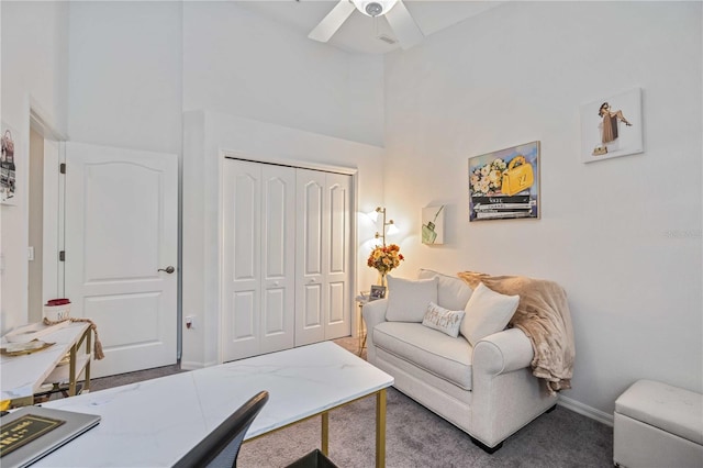 living room featuring carpet and ceiling fan