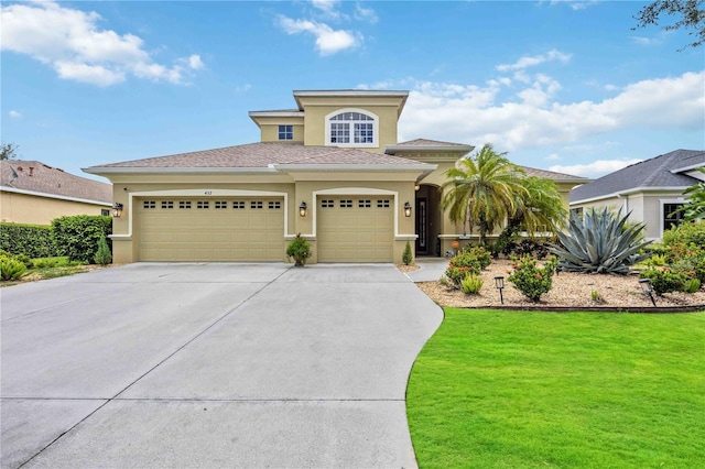 view of front facade with a garage and a front lawn