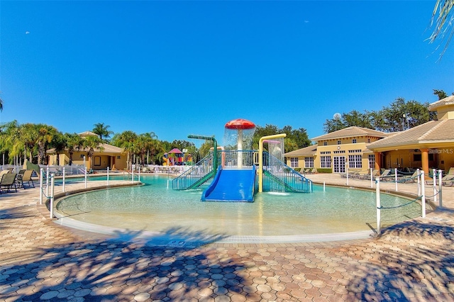 view of pool with a playground