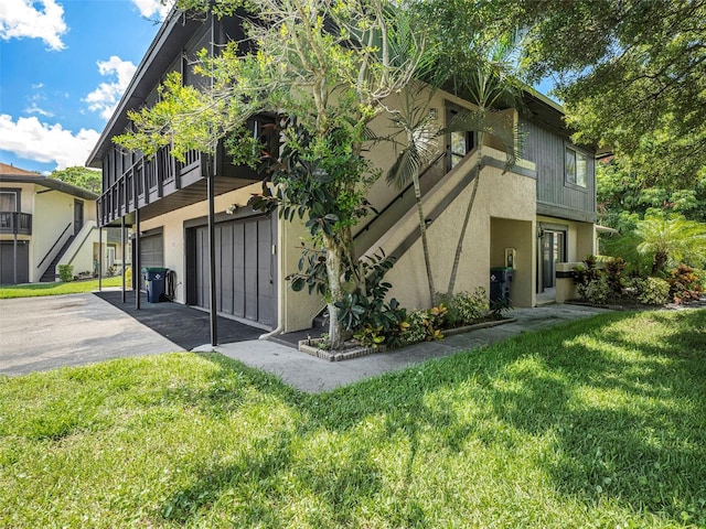 exterior space with a garage and a lawn