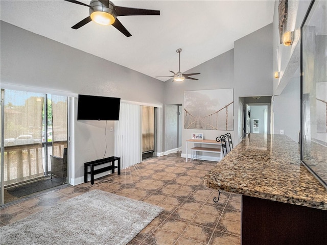 kitchen with ceiling fan and high vaulted ceiling