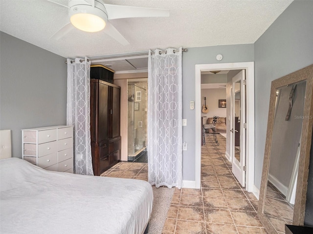 bedroom featuring light tile patterned flooring, a textured ceiling, and ceiling fan