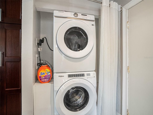 clothes washing area featuring stacked washer / drying machine