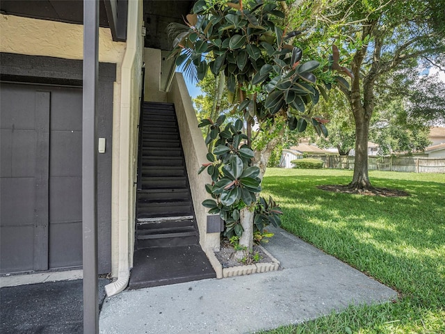 doorway to property with a lawn