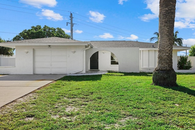 ranch-style home featuring a front yard, concrete driveway, and stucco siding