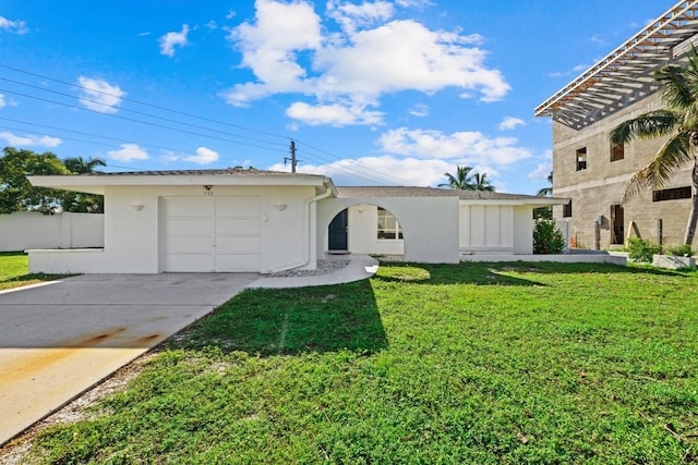 view of front of home with a garage and a front lawn