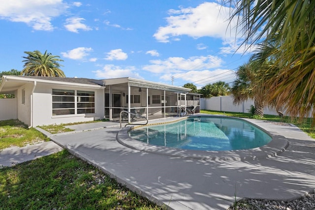 view of swimming pool with a patio and a sunroom