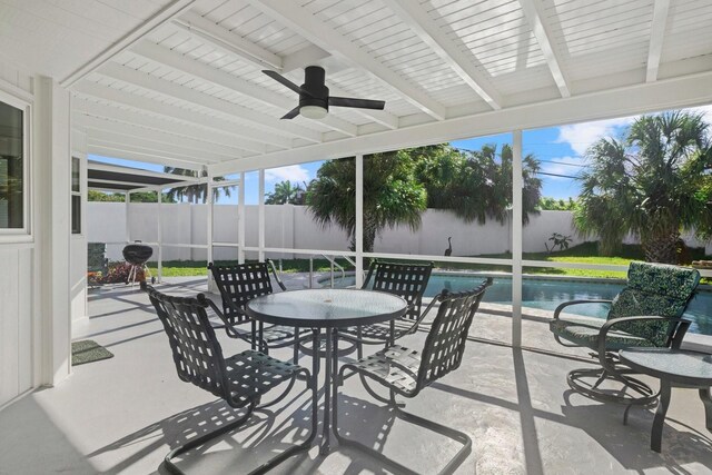 view of patio / terrace with a fenced in pool and ceiling fan