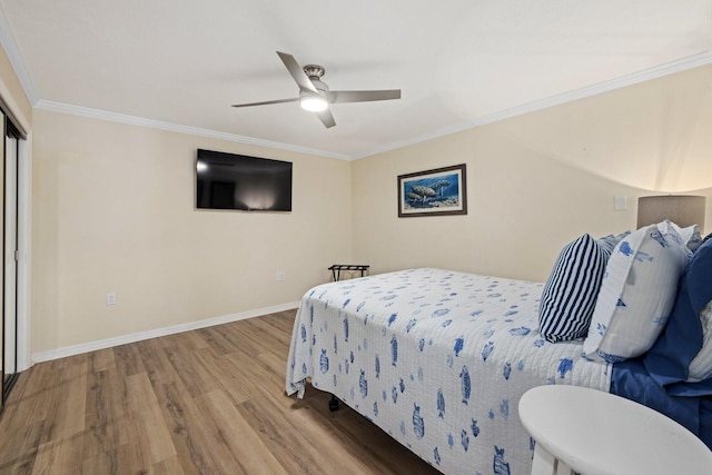 bedroom with ornamental molding, light hardwood / wood-style flooring, and ceiling fan