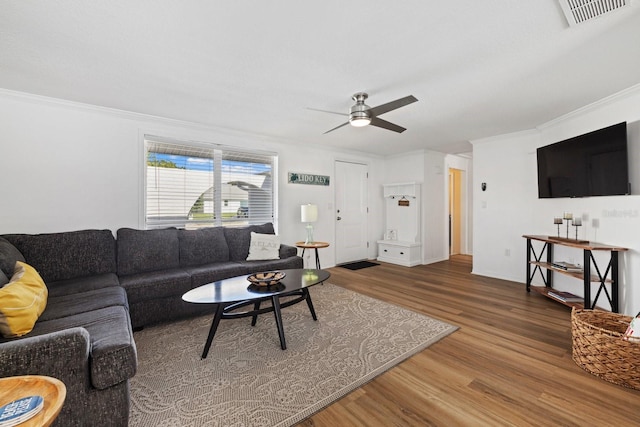 living room with ceiling fan, ornamental molding, and hardwood / wood-style flooring