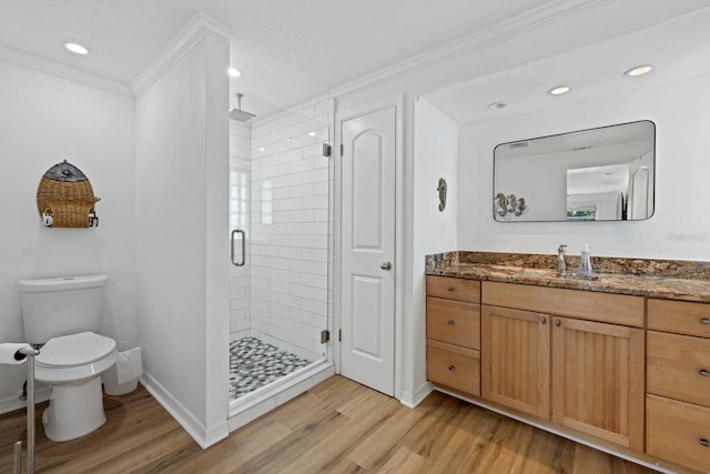 bathroom with vanity, toilet, hardwood / wood-style floors, and an enclosed shower