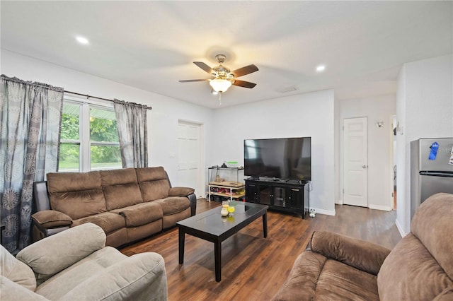 living room with ceiling fan and dark hardwood / wood-style flooring