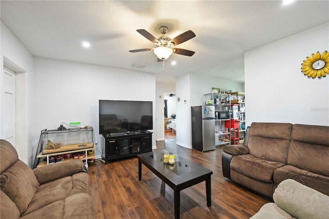 living room with ceiling fan and dark hardwood / wood-style floors