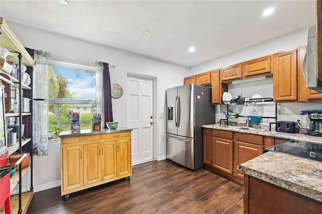 kitchen with appliances with stainless steel finishes, sink, and dark hardwood / wood-style floors