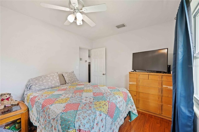 bedroom with hardwood / wood-style floors and ceiling fan