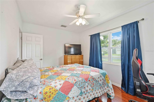 bedroom with hardwood / wood-style floors and ceiling fan